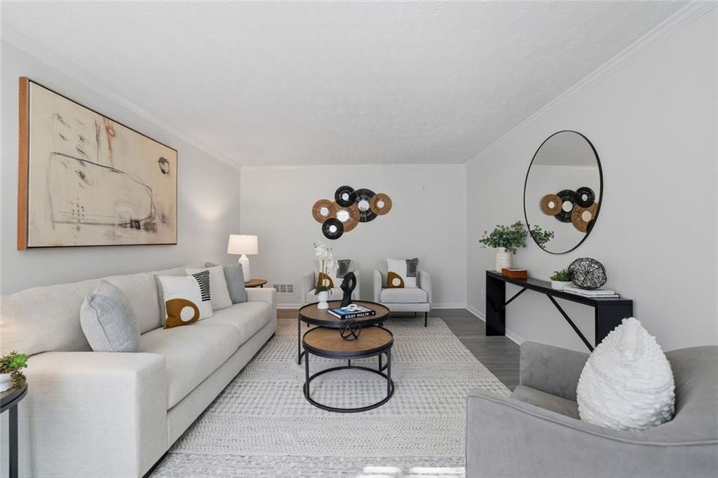 4645 Riveredge Cove Snellville, GA 30039 - Photo 3 of 43 a living room with furniture and a painting on the wall