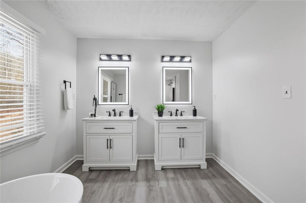 4645 Riveredge Cove Snellville, GA 30039 - Photo 31 of 43 a spacious bathroom with a toilet sink and mirror