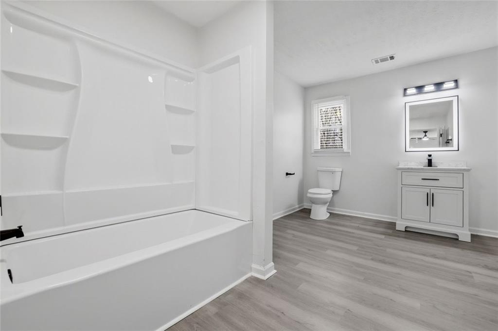 4645 Riveredge Cove Snellville, GA 30039 - Photo 34 of 43 a spacious bathroom with a bathtub sink and toilet