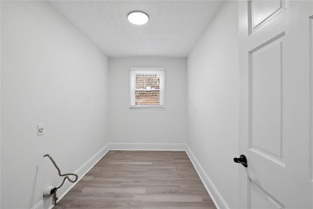 4645 Riveredge Cove Snellville, GA 30039 - Photo 35 of 43 a view of a room with wooden floor and white walls