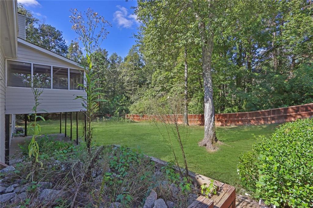 4645 Riveredge Cove Snellville, GA 30039 - Photo 40 of 43 a backyard of a house with lots of green space