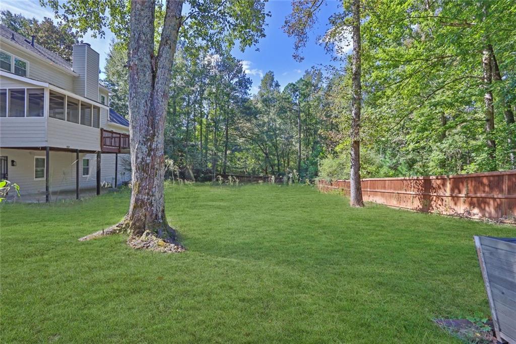 4645 Riveredge Cove Snellville, GA 30039 - Photo 42 of 43 a backyard of a house with lots of green space