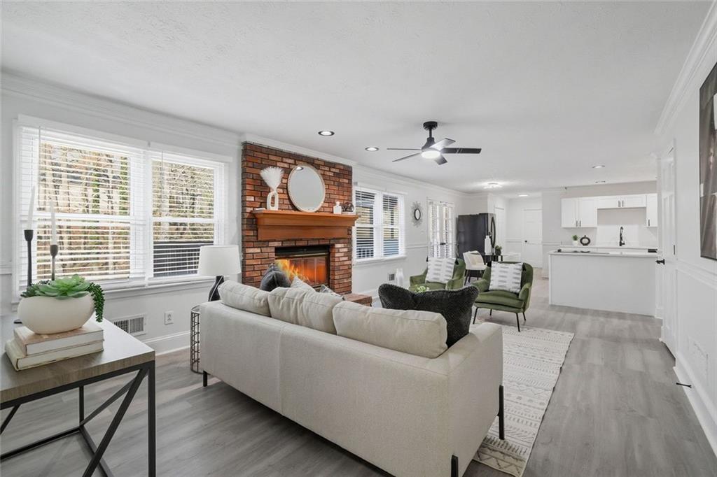 4645 Riveredge Cove Snellville, GA 30039 - Photo 7 of 43 a living room with furniture fireplace and a large window