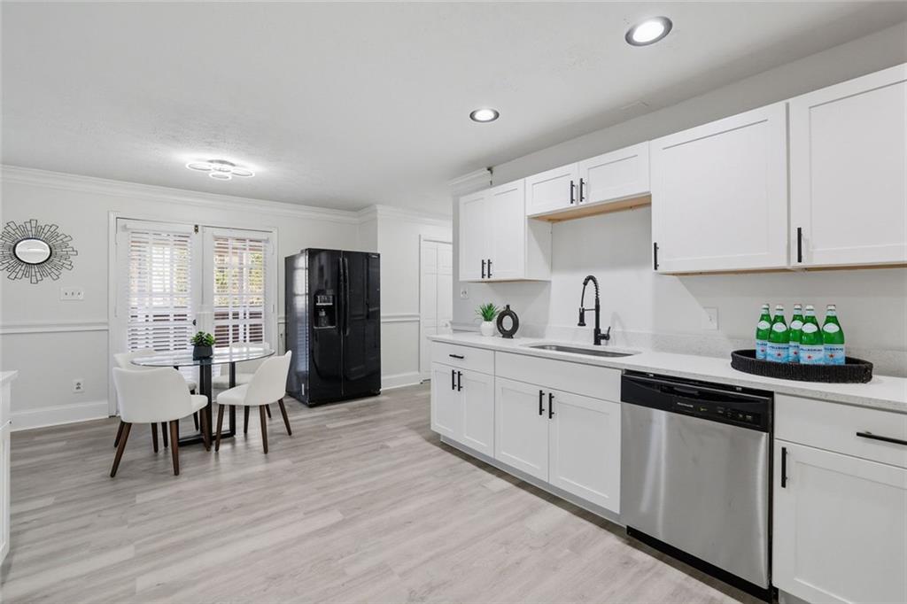 4645 Riveredge Cove Snellville, GA 30039 - Photo 9 of 43 a kitchen with white cabinets and stainless steel appliances