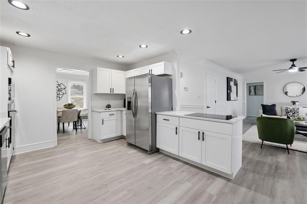 4645 Riveredge Cove Snellville, GA 30039 - Photo 10 of 43 a kitchen with a sink cabinets and wooden floor