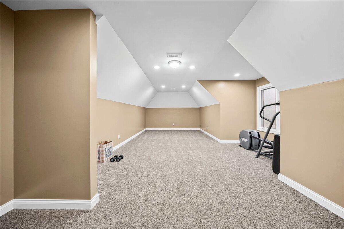 8751 Bridgewater Court Crown Point, IN 46307 - Photo 36 of 49 a view of a room with gym equipment and a chandelier