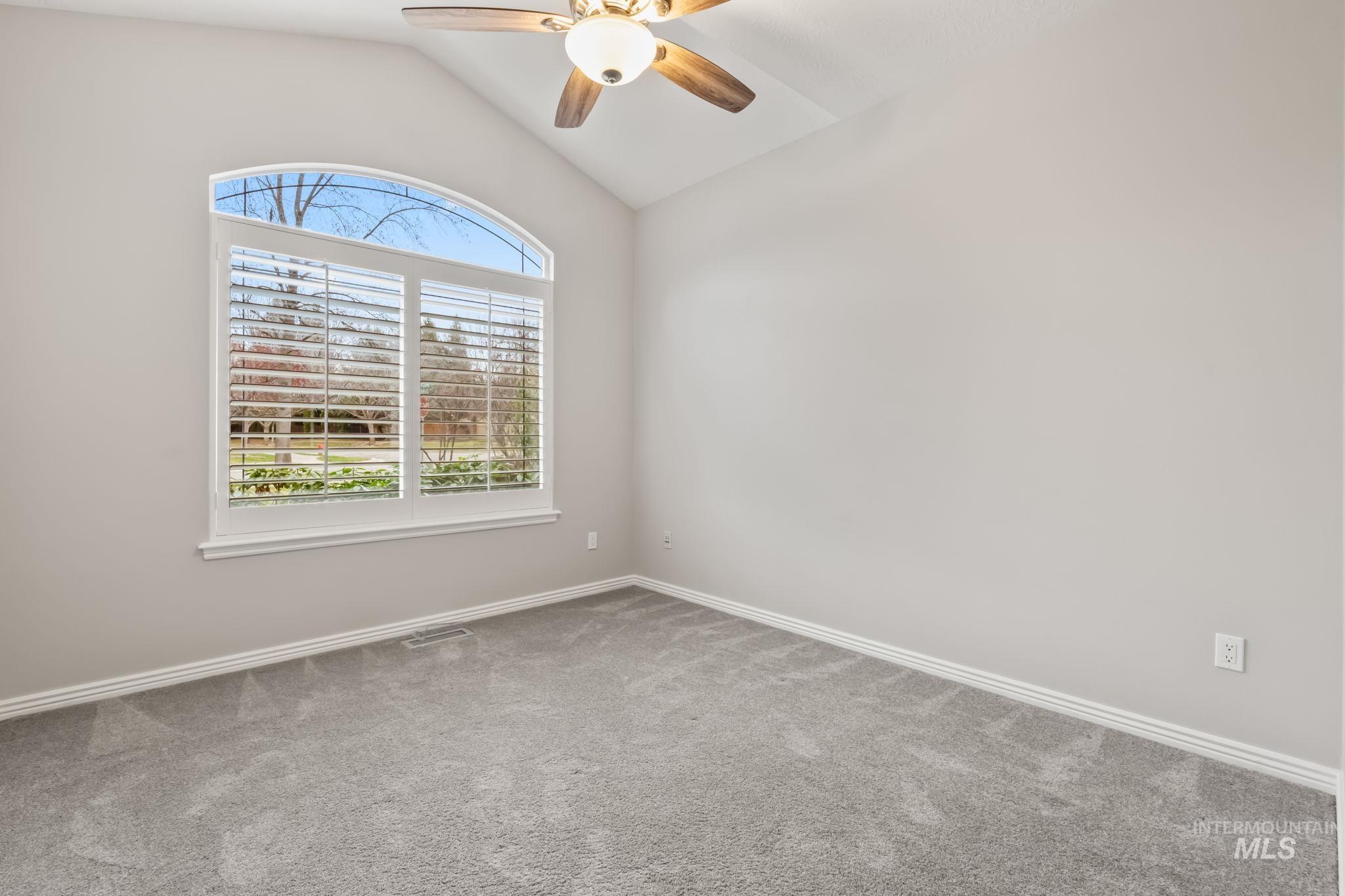 1579 North Watson Way Eagle, ID 83616 - Photo 18 of 30 Carpeted spare room featuring ceiling fan and vaulted ceiling