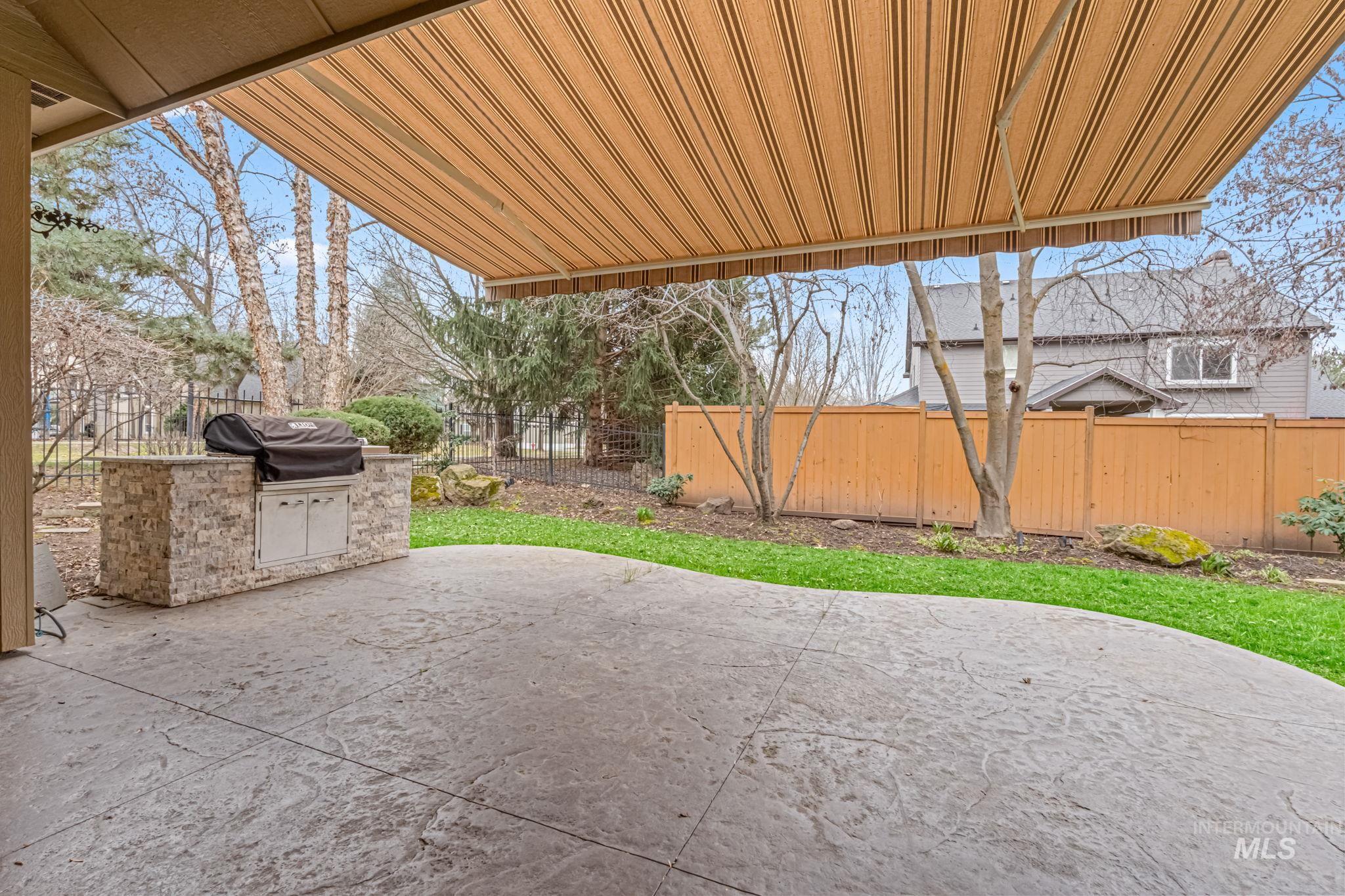 1579 North Watson Way Eagle, ID 83616 - Photo 26 of 30 Fenced backyard featuring a patio area and an outdoor kitchen