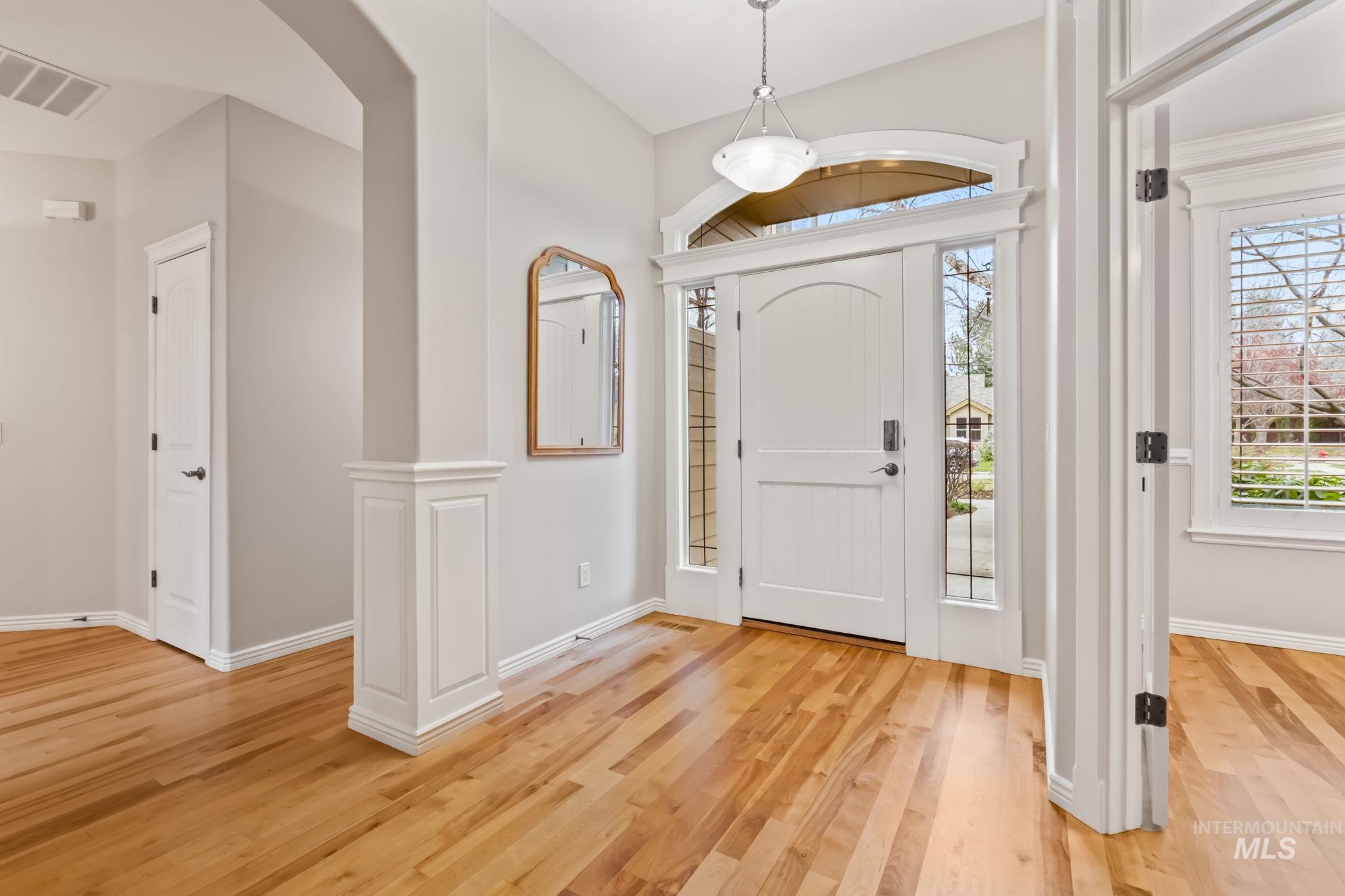 1579 North Watson Way Eagle, ID 83616 - Photo 10 of 30 Foyer entrance with light wood-type flooring and baseboards