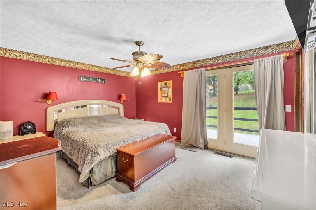 8866 Timberlink Road Northwest Canal Fulton, OH 44614 - Photo 22 of 45 master bedroom with balcony. View of the backyard