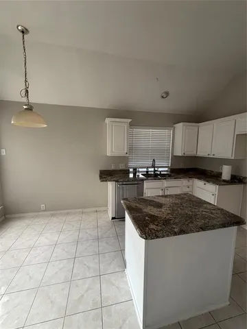 a kitchen with stainless steel appliances granite countertop a sink a stove a microwave and cabinets