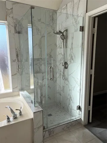 a bathroom with a shower and a sink