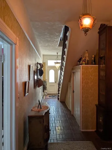a view of a livingroom with furniture wooden floor and entryway