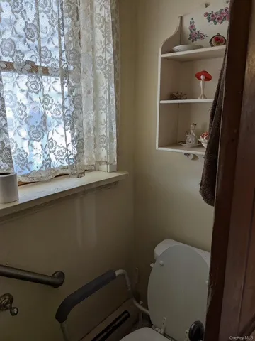 a bathroom with a toilet and a sink