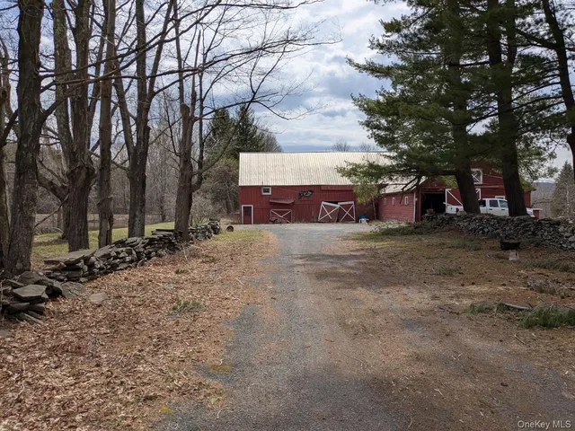 a view of a house with large trees