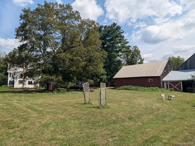 a view of a house with a yard and sitting area