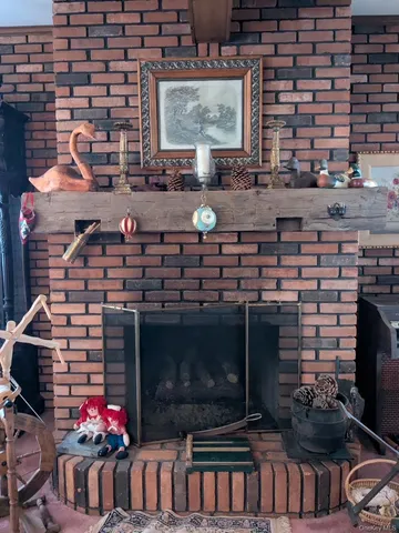 a living room with fireplace and flowers