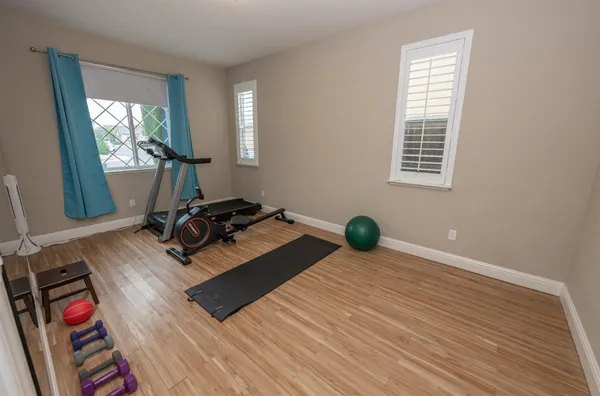 a bedroom with a bed and a television