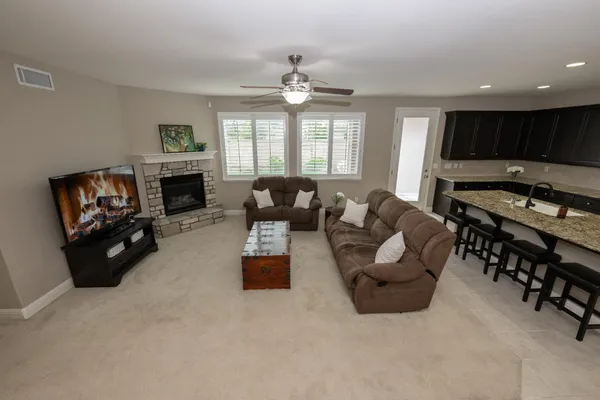 a view of house with backyard and outdoor seating