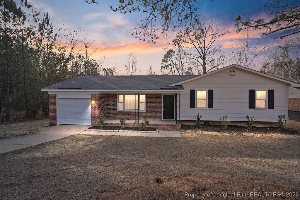 a backyard of a house with barbeque oven table and chairs