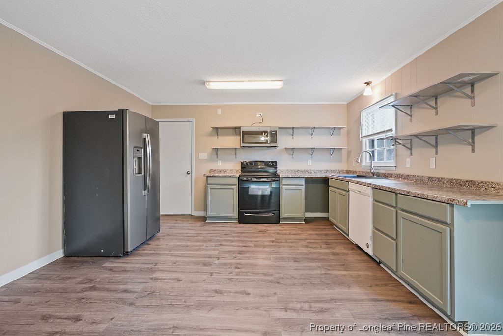 5314 Hornbeam Road Fayetteville, NC 28304 - Photo 5 of 15 a kitchen with stainless steel appliances granite countertop a stove top oven and cabinets