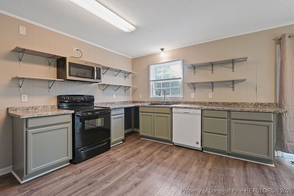 5314 Hornbeam Road Fayetteville, NC 28304 - Photo 6 of 15 a kitchen with stainless steel appliances granite countertop a sink cabinets and wooden floor