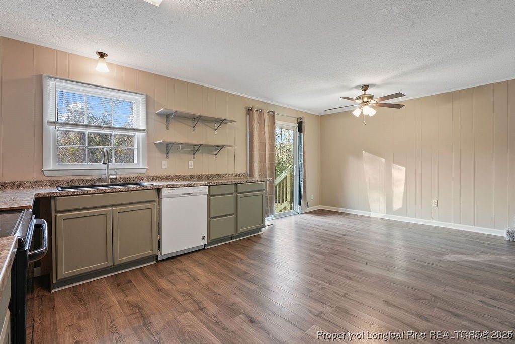 5314 Hornbeam Road Fayetteville, NC 28304 - Photo 7 of 15 a kitchen with stainless steel appliances granite countertop a sink cabinets and wooden floor