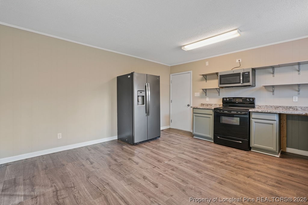 5314 Hornbeam Road Fayetteville, NC 28304 - Photo 8 of 15 a kitchen with stainless steel appliances granite countertop a refrigerator and a stove top oven