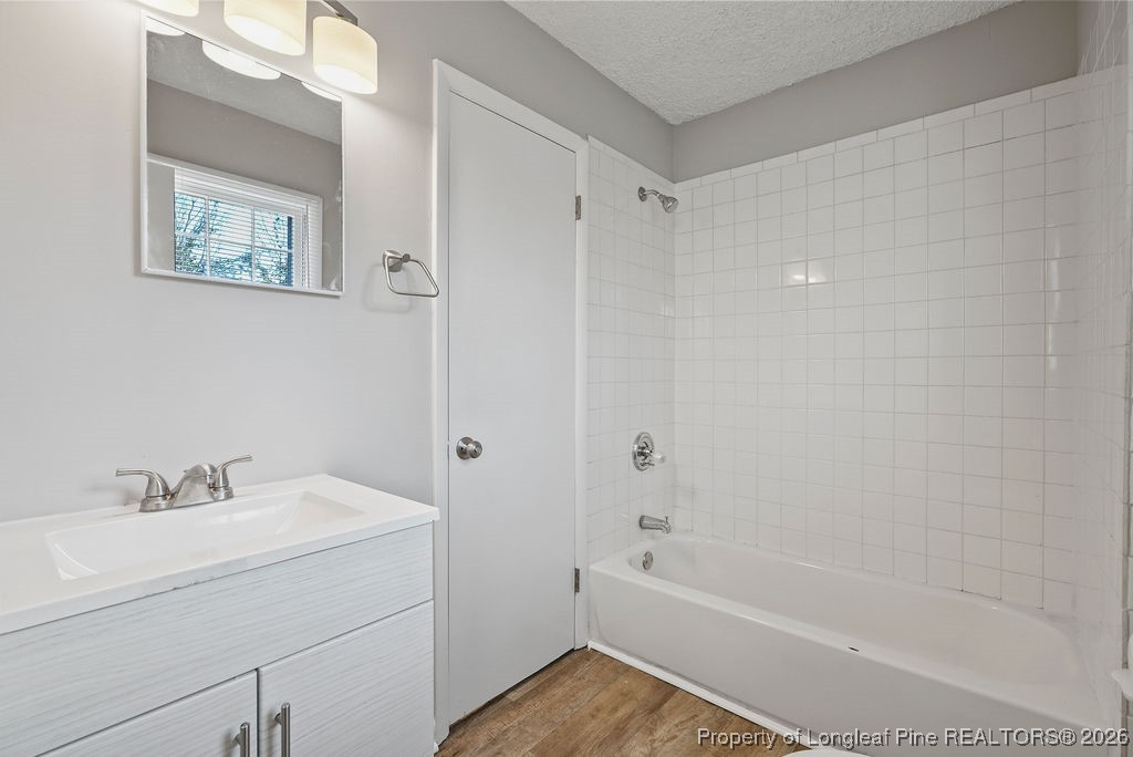 5314 Hornbeam Road Fayetteville, NC 28304 - Photo 10 of 15 a bathroom with a bathtub a sink a vanity and a shower