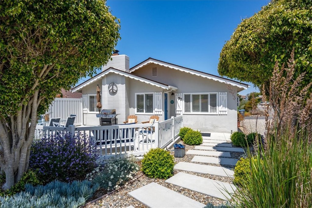 57 17th Street Cayucos, CA 93430 - Photo 1 of 24 a view of a house with a small yard and potted plants