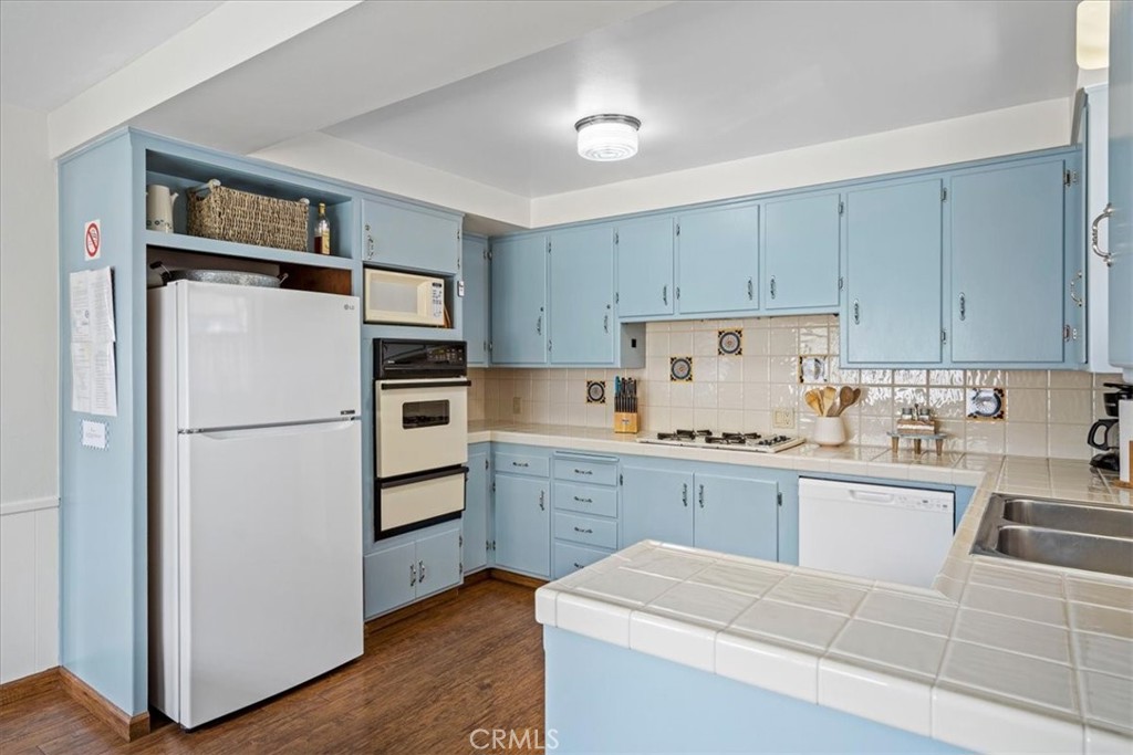 57 17th Street Cayucos, CA 93430 - Photo 12 of 24 a kitchen with cabinets stainless steel appliances and wooden floor