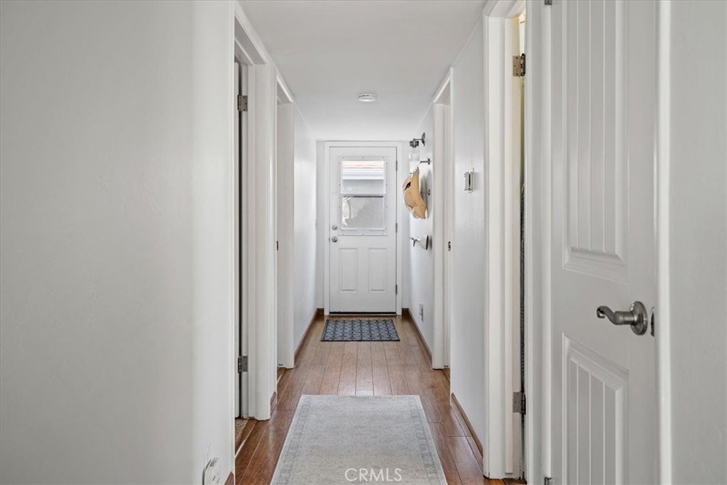 57 17th Street Cayucos, CA 93430 - Photo 13 of 24 a view of a hallway with wooden floor and a bathroom