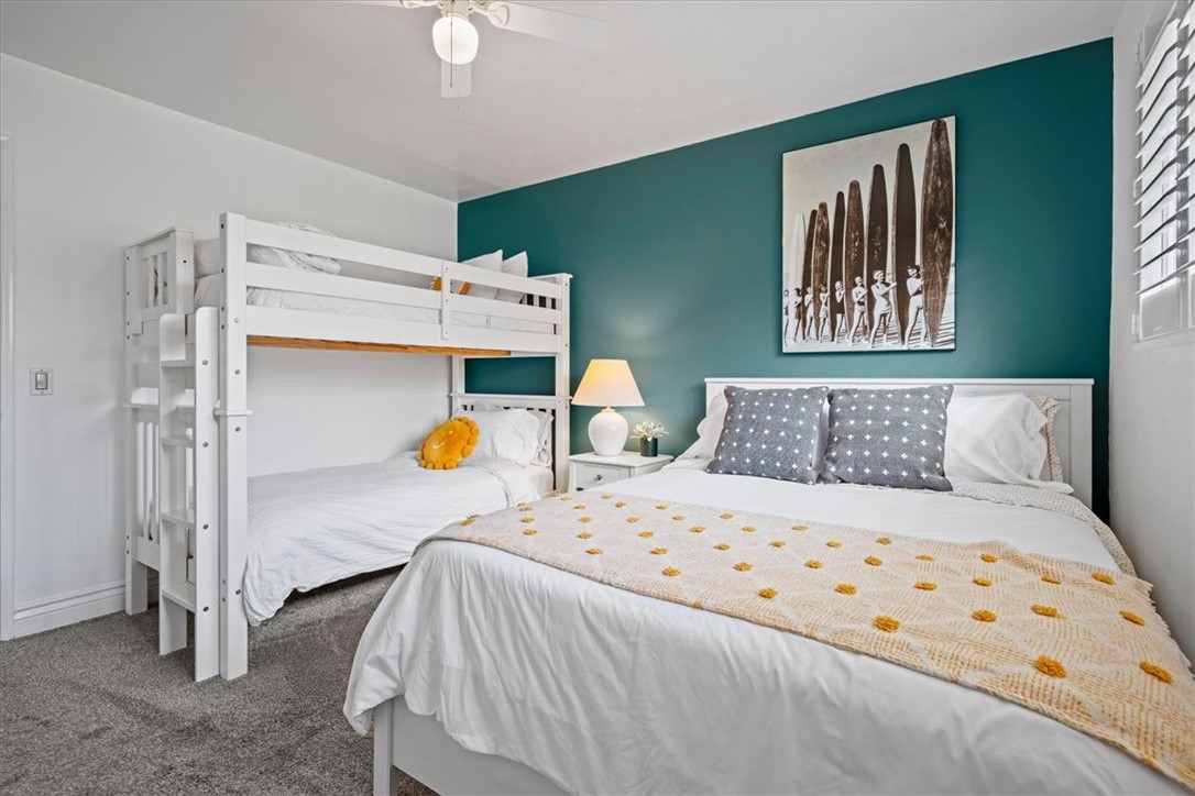 57 17th Street Cayucos, CA 93430 - Photo 15 of 24 a bedroom with a bed and a chandelier