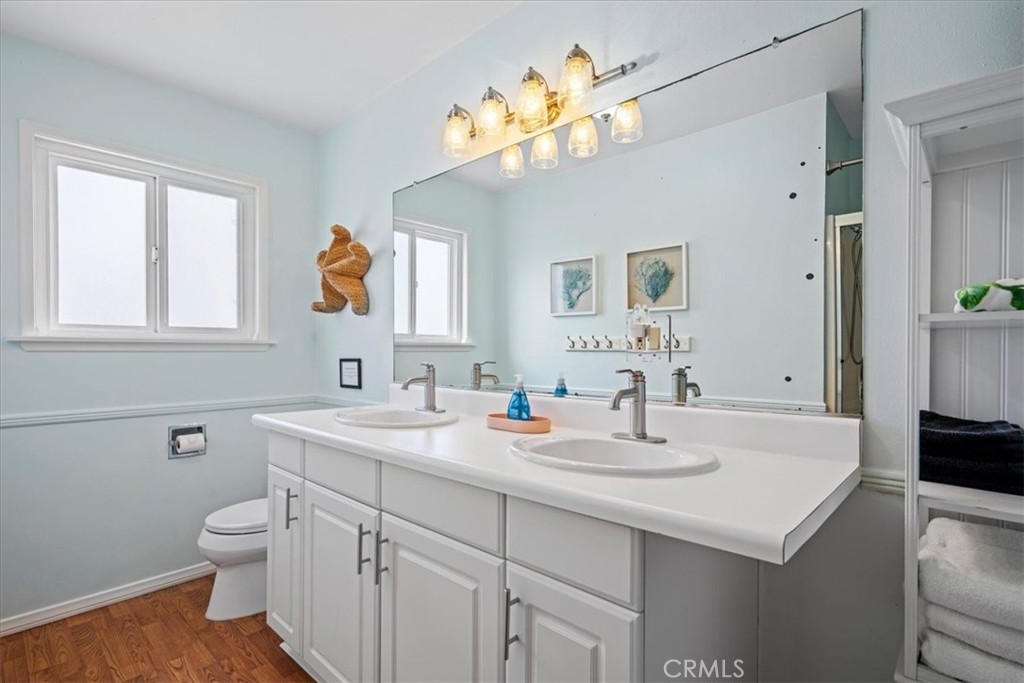 57 17th Street Cayucos, CA 93430 - Photo 16 of 24 a bathroom with a sink a toilet and a mirror