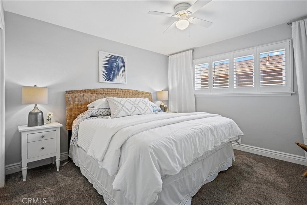 57 17th Street Cayucos, CA 93430 - Photo 18 of 24 a bedroom with a large bed and a chandelier