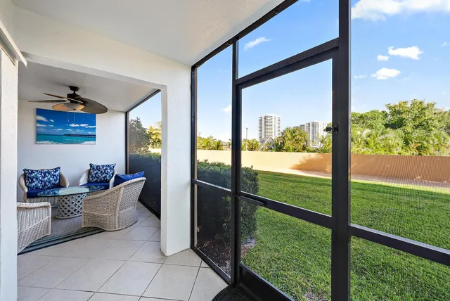 a view of two room with furniture and floor to ceiling window