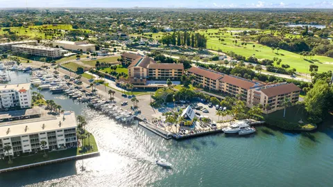 an aerial view of lake and residential houses with outdoor space