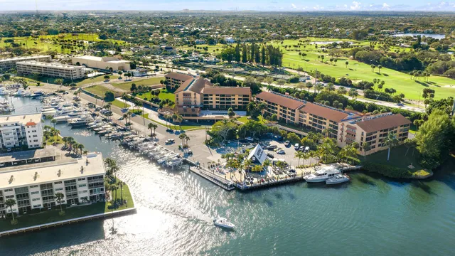 an aerial view of lake and residential houses with outdoor space