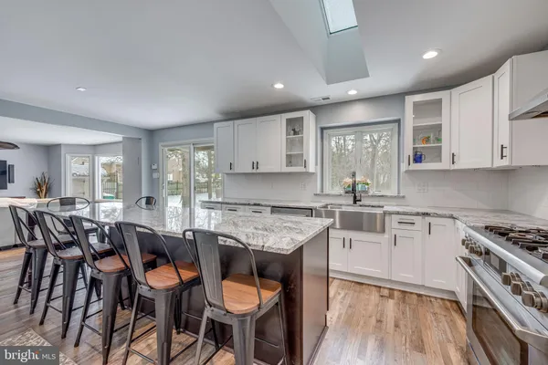 a kitchen with cabinets table and chairs