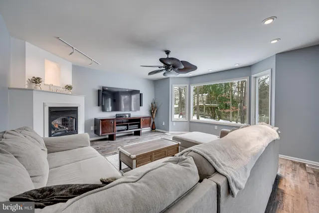 a living room with furniture a fireplace and a flat screen tv