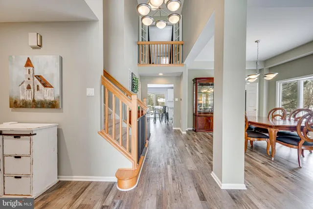 a view of a hallway view with wooden floor and staircase