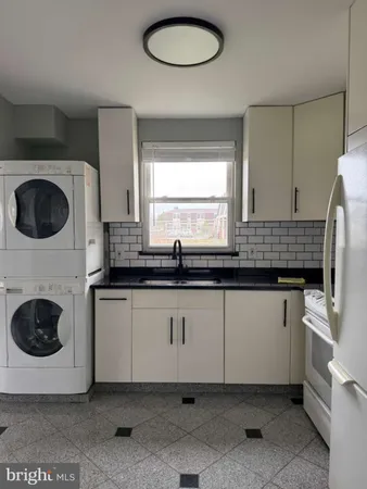 a kitchen with a sink a stove and cabinets