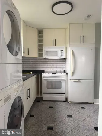a white refrigerator freezer sitting inside of a kitchen