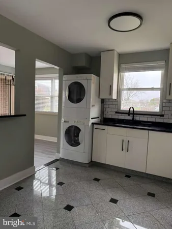 a kitchen with a stove a sink and a microwave