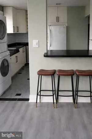 a living room with a wooden floor furniture and a flat screen tv