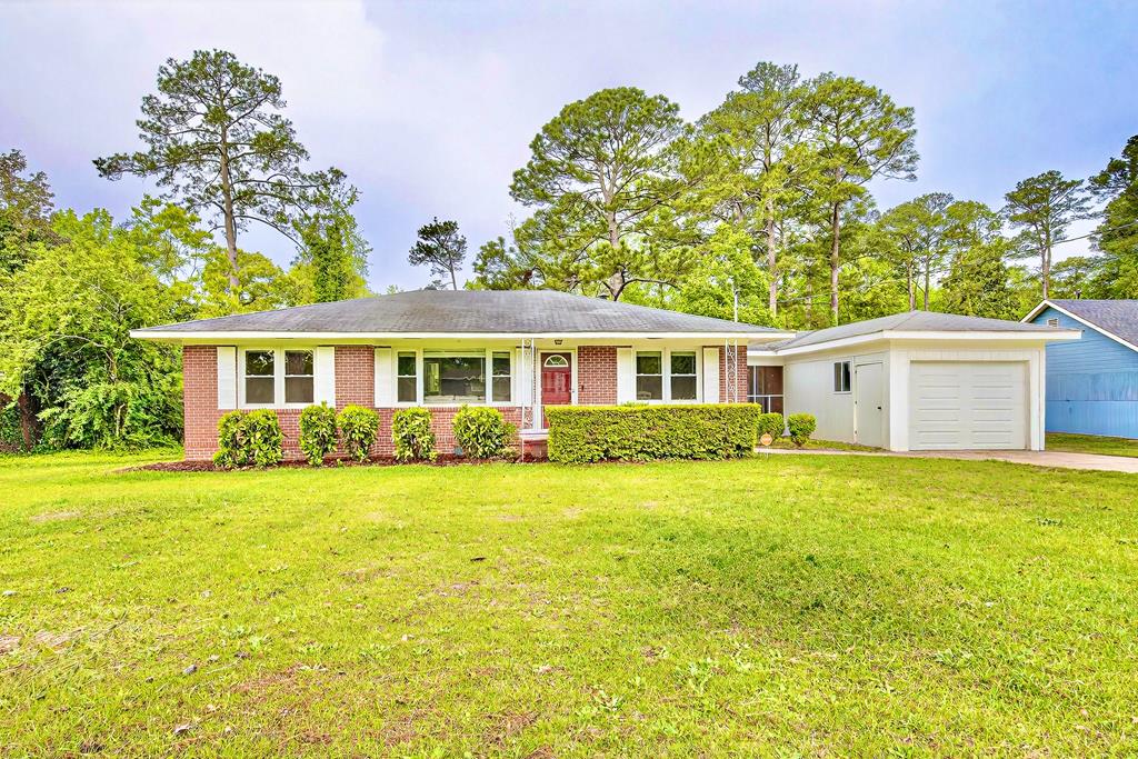 a front view of a house with a garden
