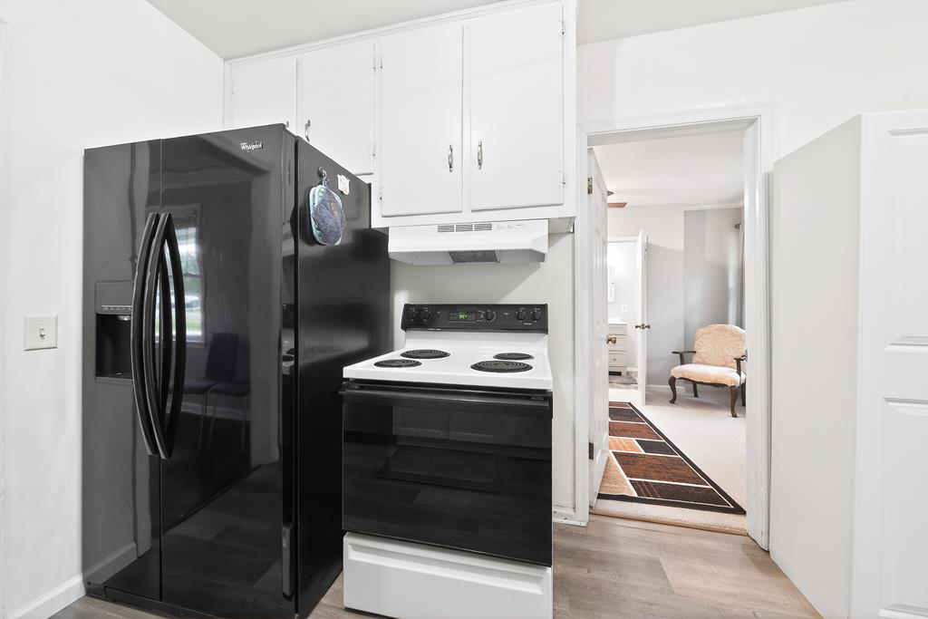 5829 Dearborn Avenue Columbus, GA 31909 - Photo 12 of 29 a kitchen with a refrigerator and white cabinets