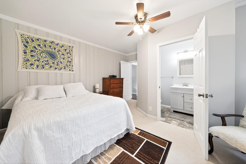 5829 Dearborn Avenue Columbus, GA 31909 - Photo 14 of 29 a spacious bedroom with a bed and a couch