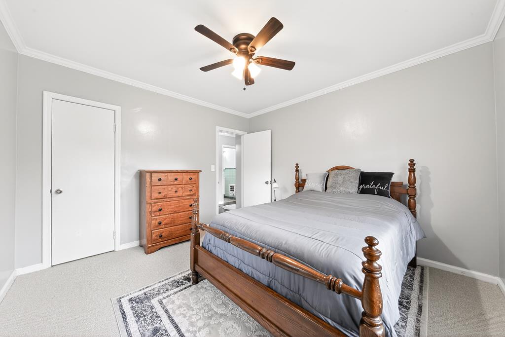 5829 Dearborn Avenue Columbus, GA 31909 - Photo 18 of 29 a bedroom with a bed and a ceiling fan