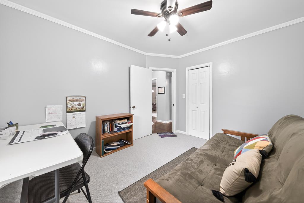 5829 Dearborn Avenue Columbus, GA 31909 - Photo 22 of 29 a bedroom with a bed and a chandelier